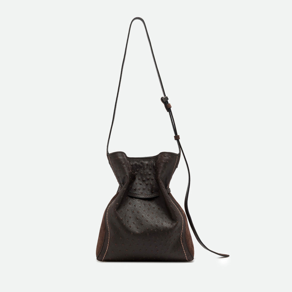 Back of a dark brown textured leather bucket bag