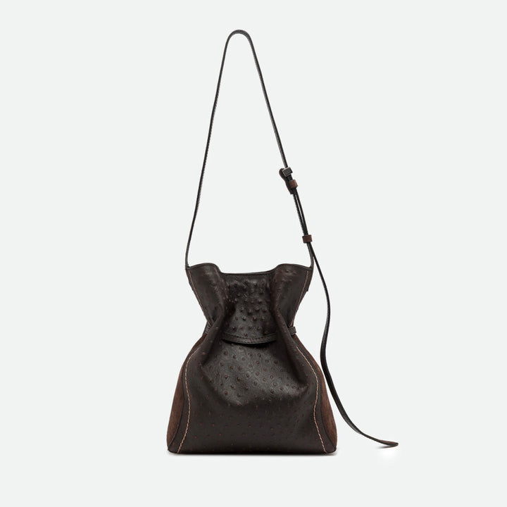 Back of a dark brown textured leather bucket bag