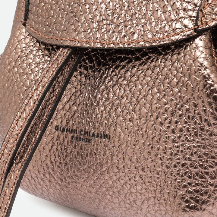 Close-up of bronze metallic pebbled leather with a drawstring and embossed logo
