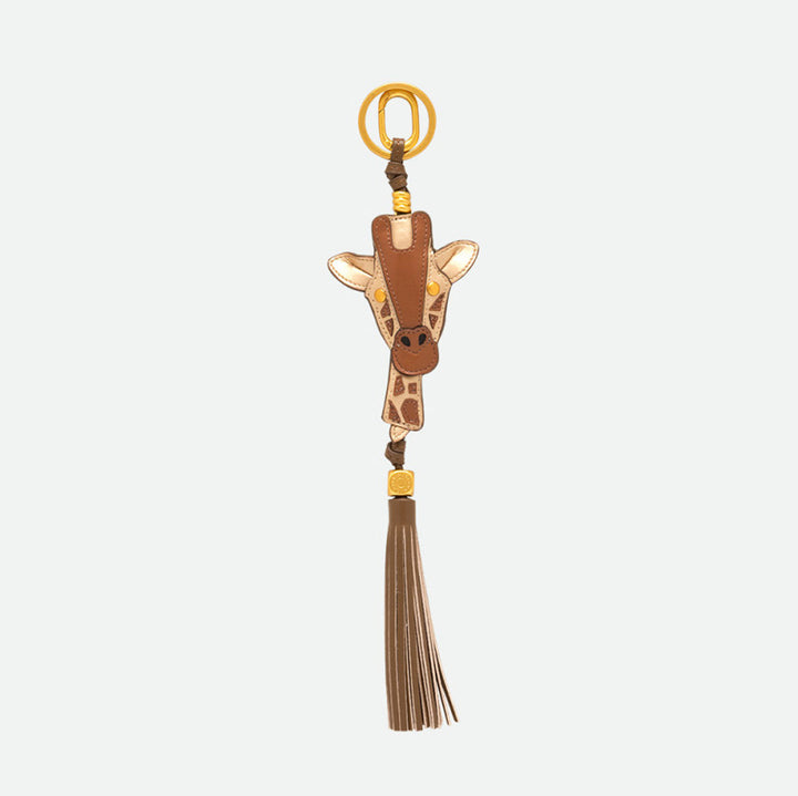 Reverse side of a giraffe bag charm with a long brown tassel