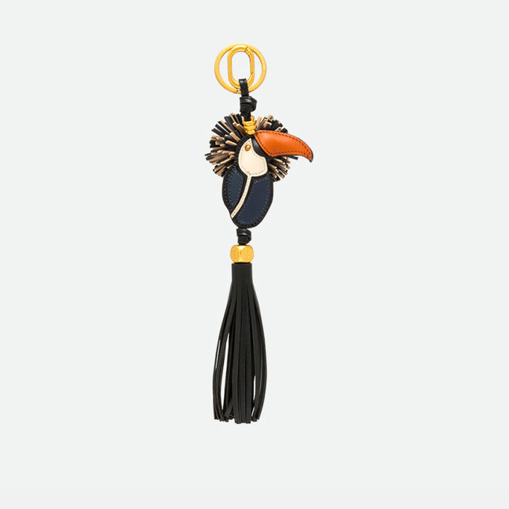 Toucan bag charm with an orange beak, navy and cream body and a long black tassel