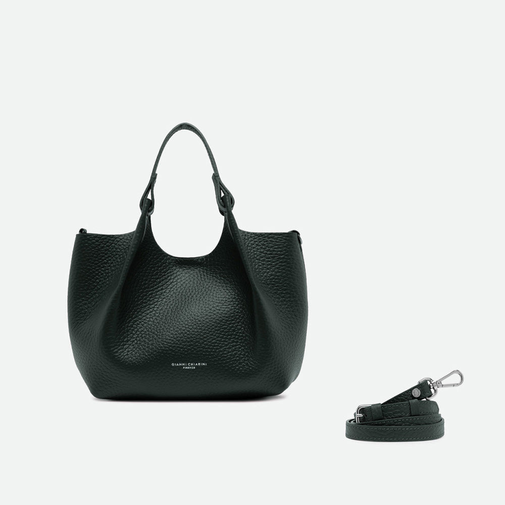Dark green leather tote with its sides opened out, beside a separate shoulder strap