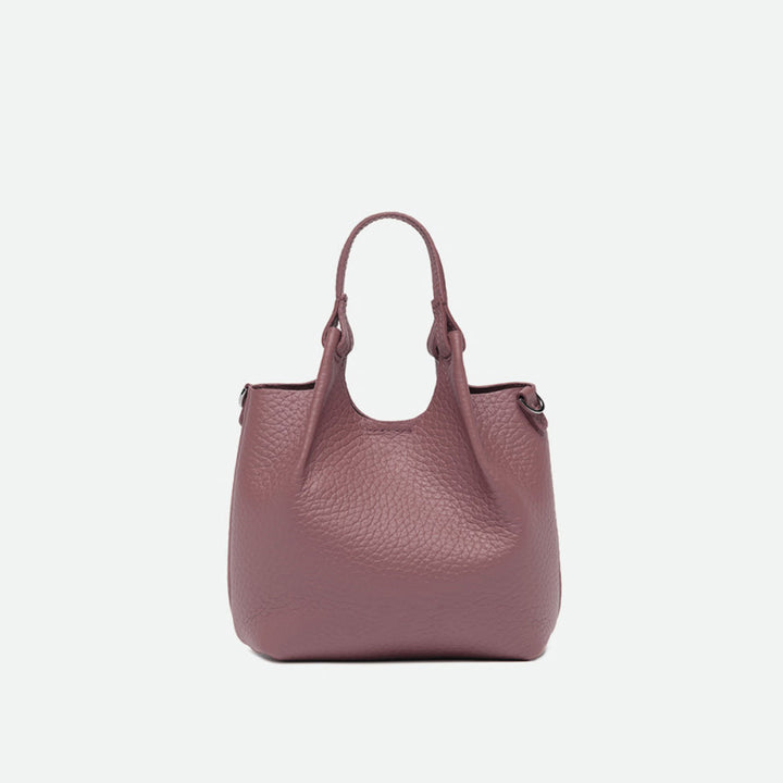 Front of a small dusty pink pebbled leather tote with its sides opened out