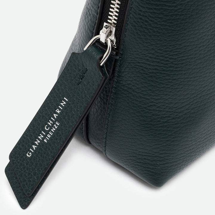 Close-up of a silver zip and dark green leather pull tag