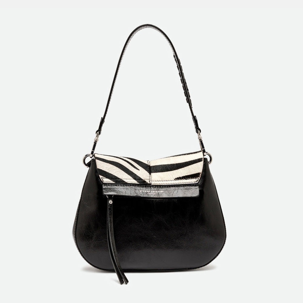 Back of a zebra print shoulder bag showing glossy black leather and a zip pocket