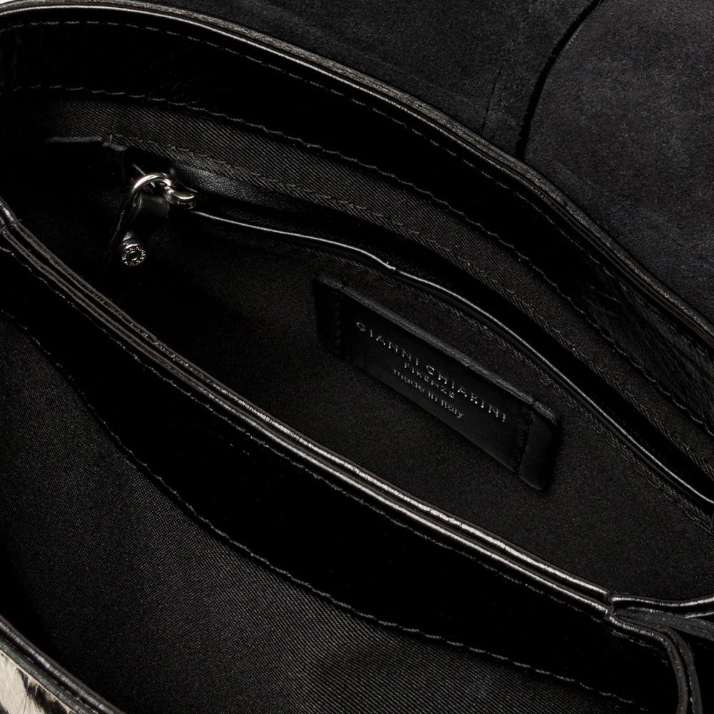 Inside a zebra print bag showing a black lining and zip pocket