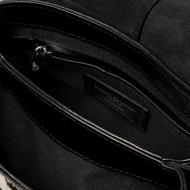 Inside a zebra print bag showing a black lining and zip pocket