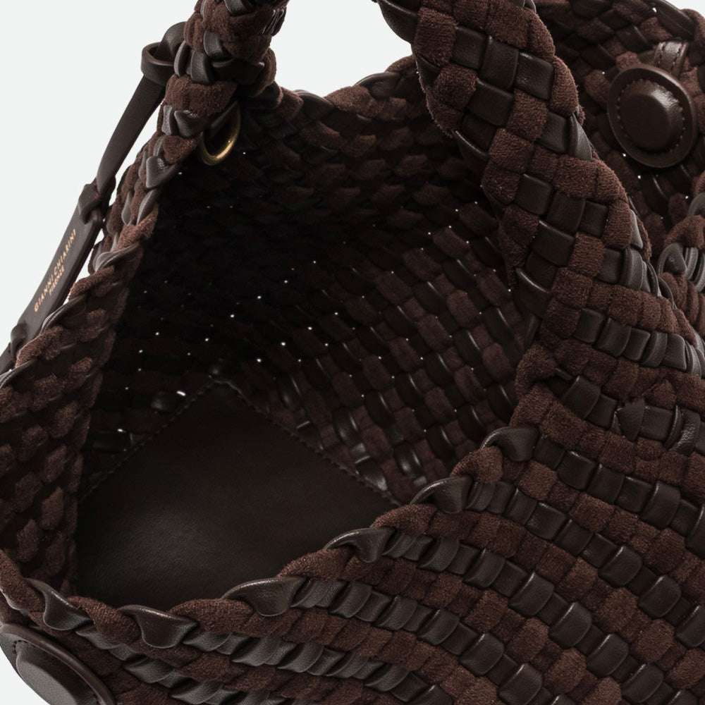 Inside a dark brown woven leather bag showing the suede interior