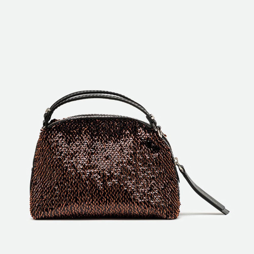 Front of a small bronze sequinned handbag with a zip top