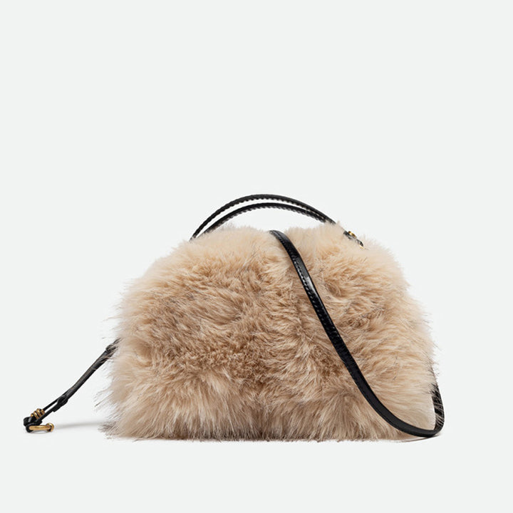 Small cream faux fur handbag with black leather handles and a crossbody strap