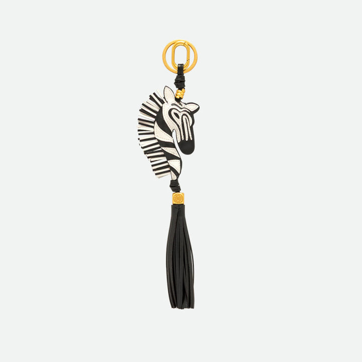 Zebra head bag charm in black and cream with a long black tassel and gold ring clasp