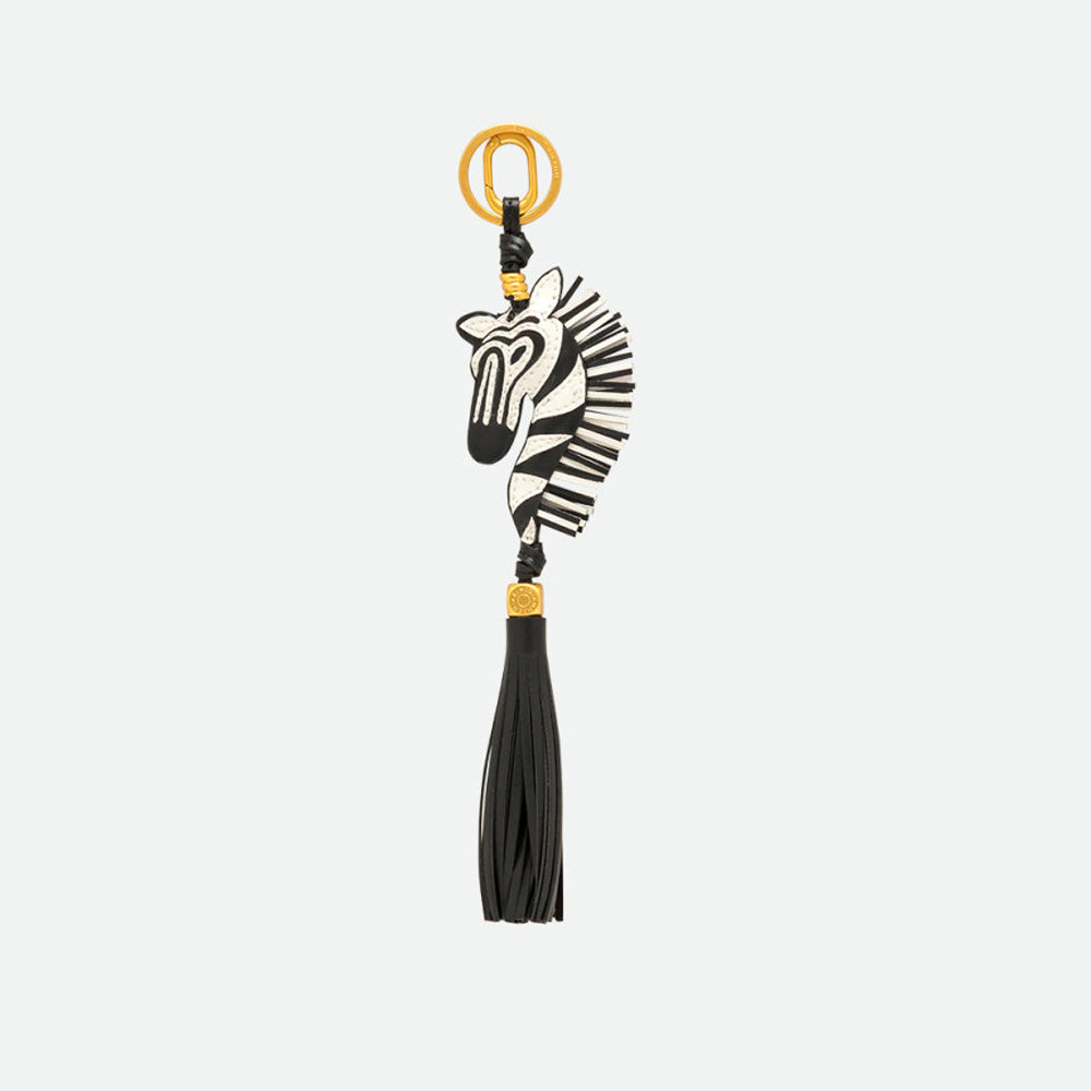 Reverse side of a zebra bag charm with a long black tassel