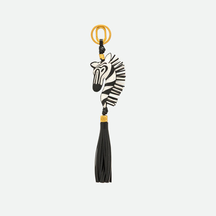Reverse side of a zebra bag charm with a long black tassel