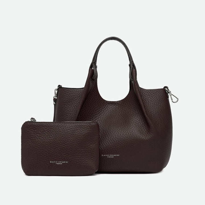 Dark brown leather tote bag shown with a matching zip pouch