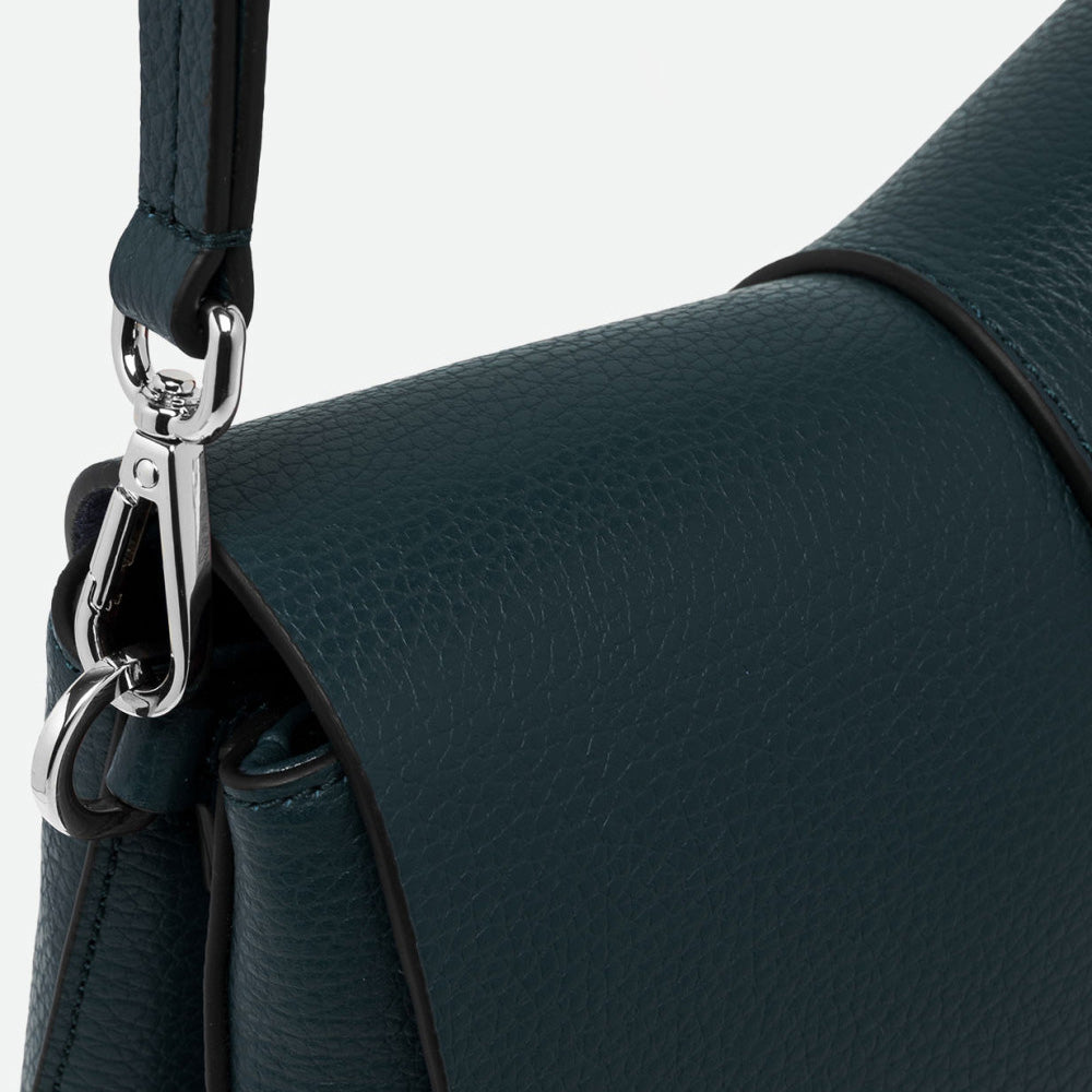 Close-up of a silver clasp and dark green pebbled leather