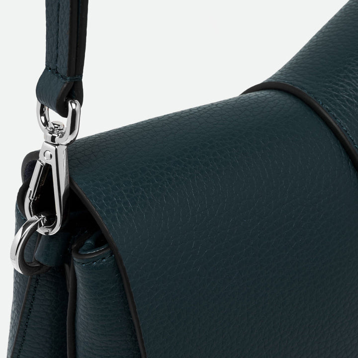 Close-up of a silver clasp and dark green pebbled leather