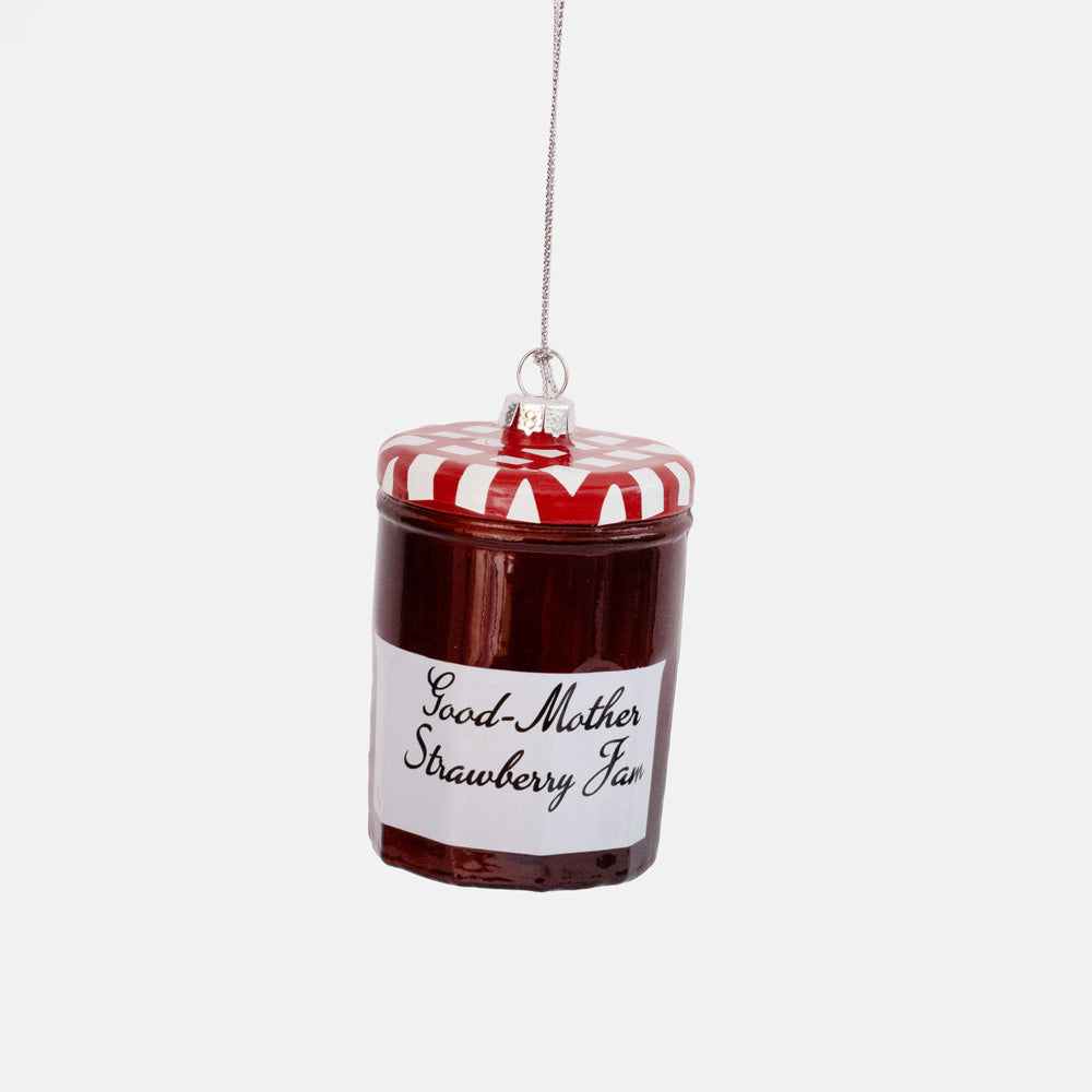 Glass ornament shaped like a jar of red strawberry jam with a red and white lid and white handwritten label