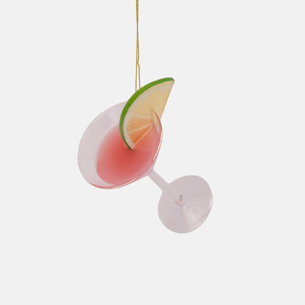Clear glass ornament shaped like a cocktail glass with a pink drink and a green lime wedge on the rim