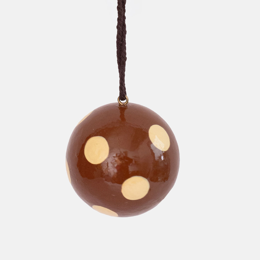Glossy chestnut brown round bauble with large cream dots, hanging from a dark brown cord