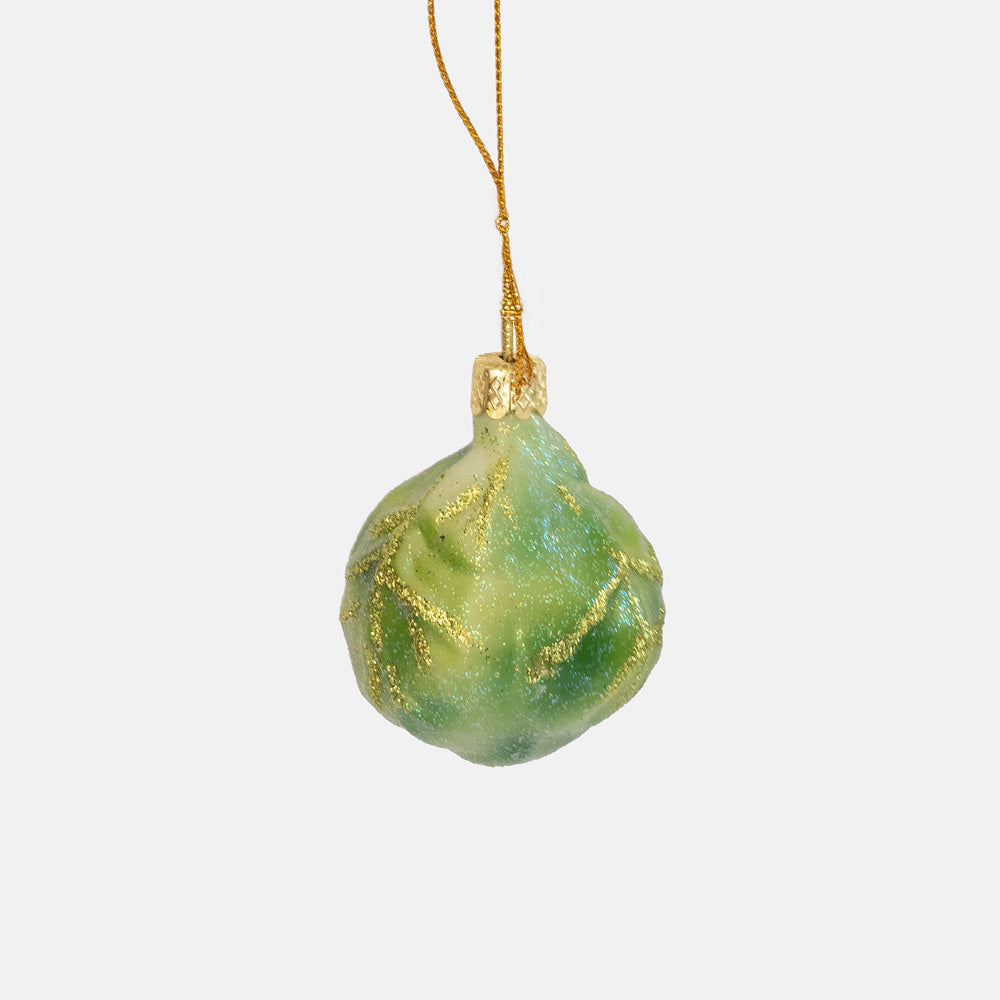 Round green glass ornament shaped like a Brussels sprout with gold glitter, hung from a gold cap and string