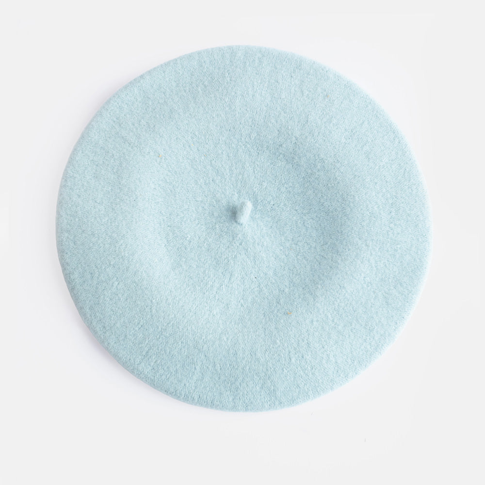 A light blue felt beret hat photographed from directly above on a clean white background.