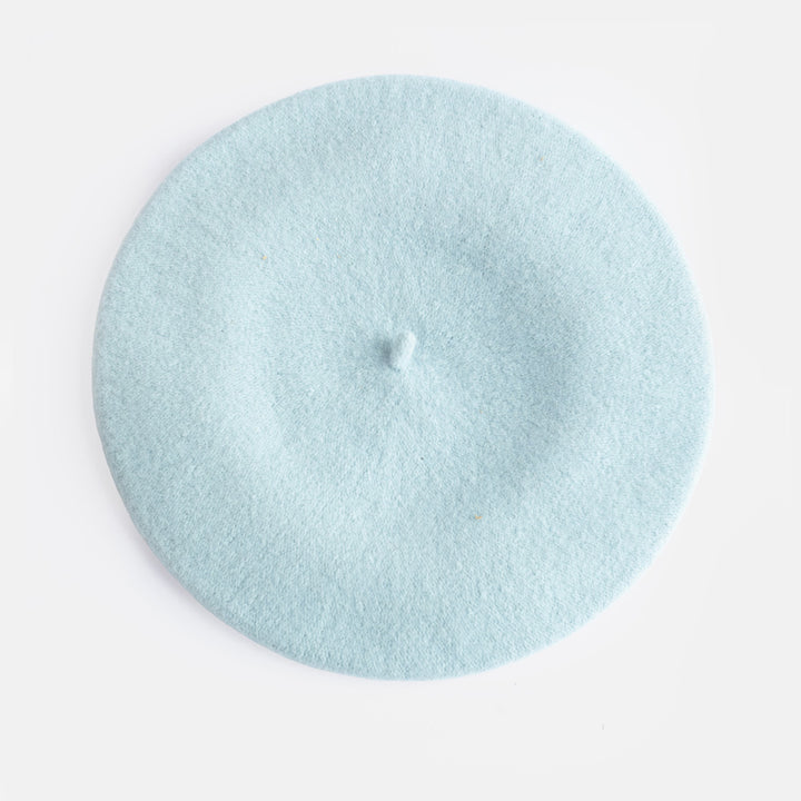A light blue felt beret hat photographed from directly above on a clean white background.