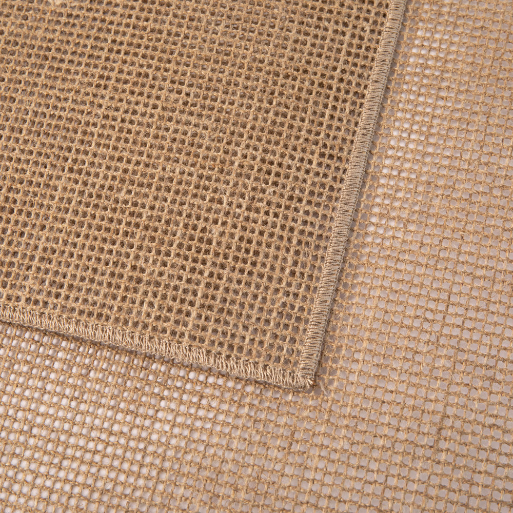 Close-up of beige woven fabric with a corner showing.