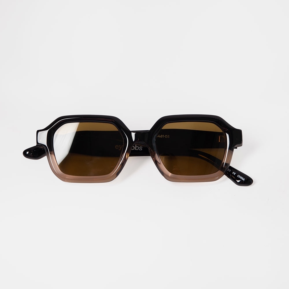 Sunglasses with brown lenses and black frames on a white background