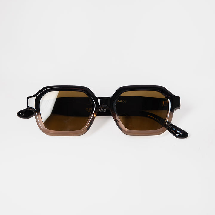 Sunglasses with brown lenses and black frames on a white background