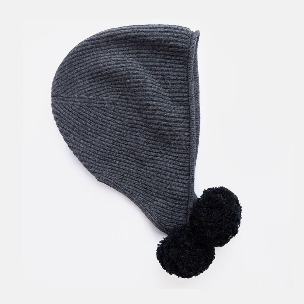 A dark gray ribbed knit bonnet hat with two black pom-poms, shown on a clean white background.