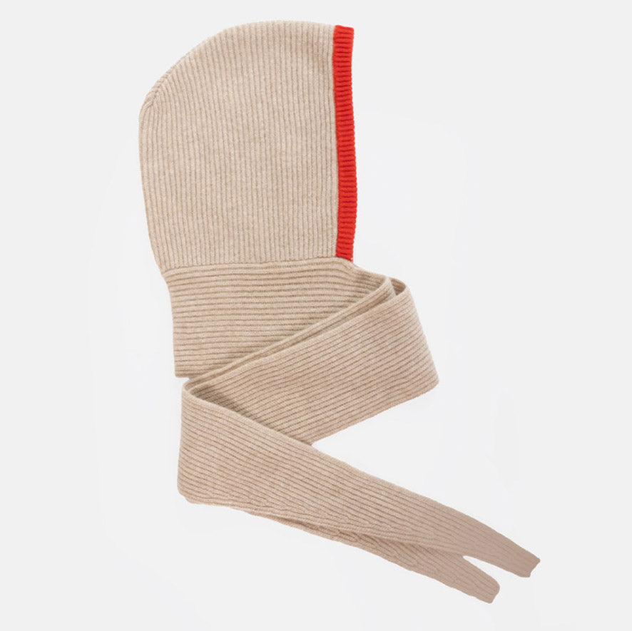 A beige ribbed knit hooded scarf with a bright red trim around the face of the hood, shown on a plain white background.