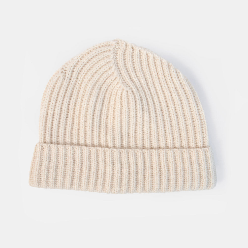 A cream-colored ribbed knit beanie hat with a folded cuff, shown against a plain white background.