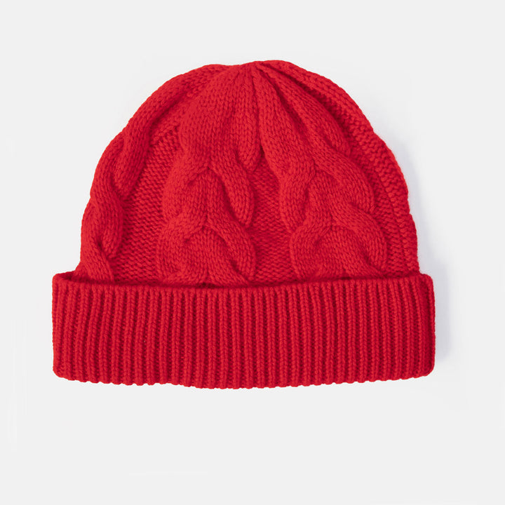 A bright red cable-knit beanie hat with a folded ribbed cuff, shown against a plain light gray background.