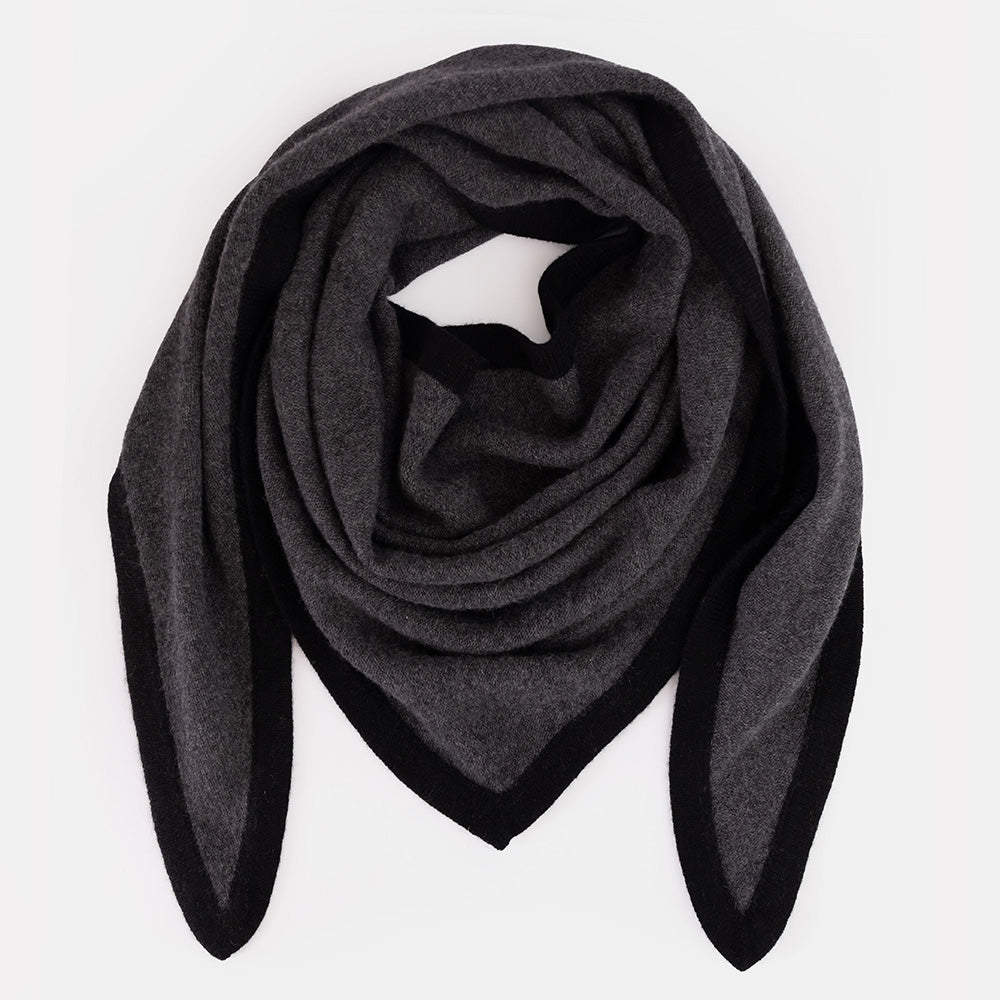 A large dark grey organic cashmere triangle scarf with a black border, styled in a loose loop on a white background.