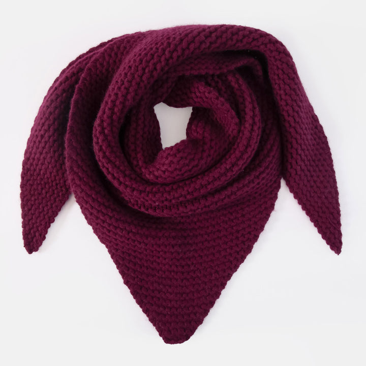A chunky-knit triangular scarf in deep burgundy, folded and displayed on a clean white background.