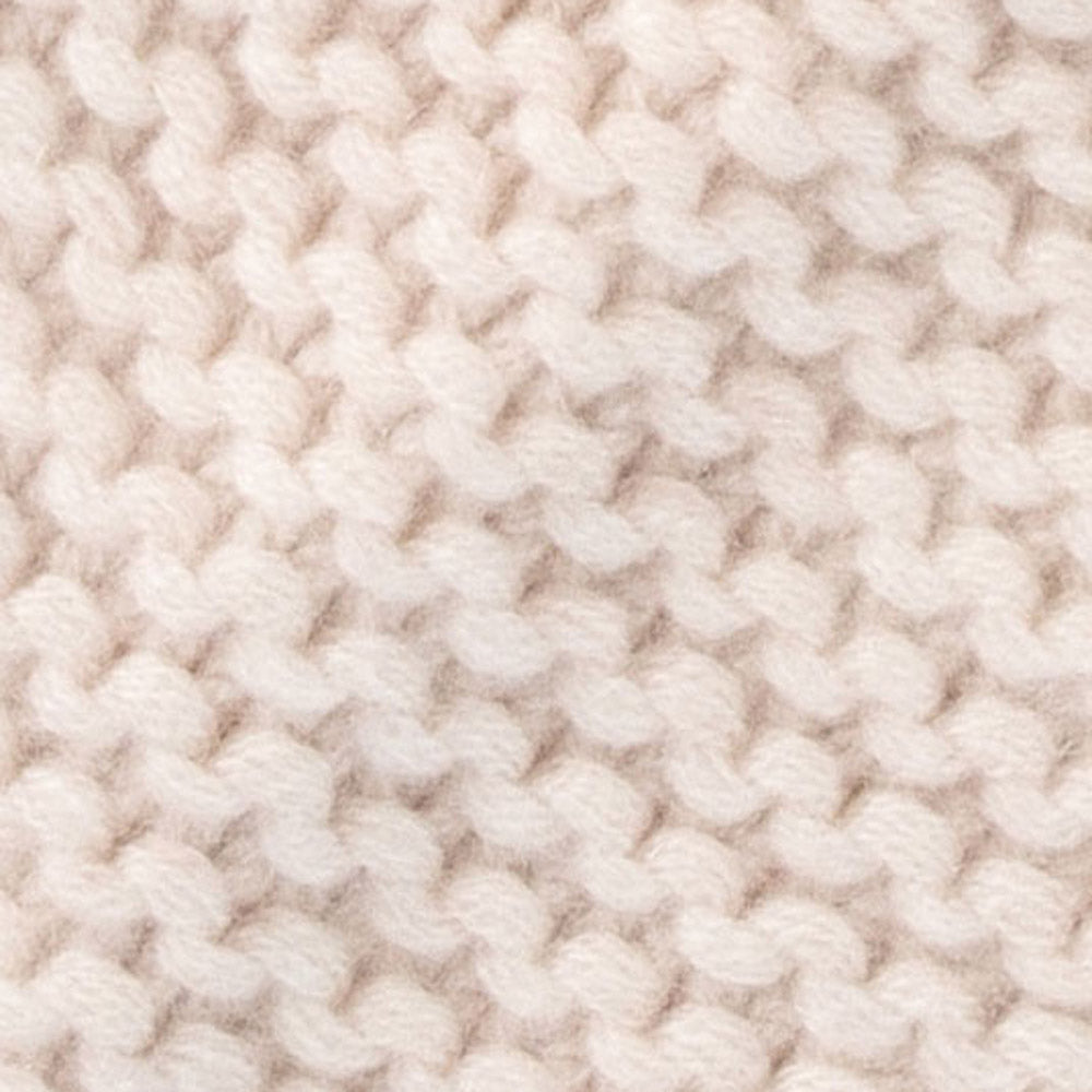 A close-up of a chunky knit fabric in a warm off-white or cream color, showing the detailed texture of the yarn stitches.