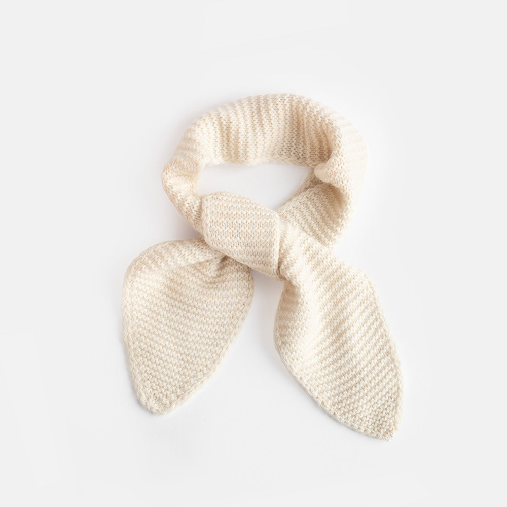 A cream-colored, textured knit mini scarf with tapered ends, photographed on a clean white background.