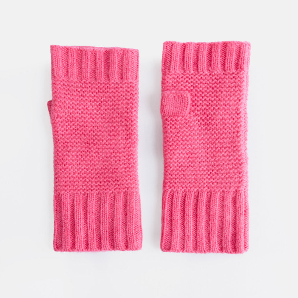A pair of bright pink hand warmers with ribbed cuffs and knitted texture, displayed flat against a clean white background.