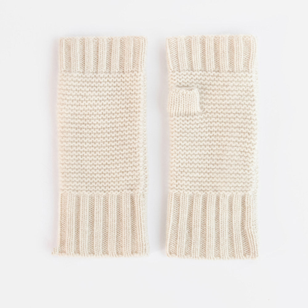 A pair of cream-colored, ribbed-knit fingerless gloves with a small tab detail on one glove, displayed flat against a white background.