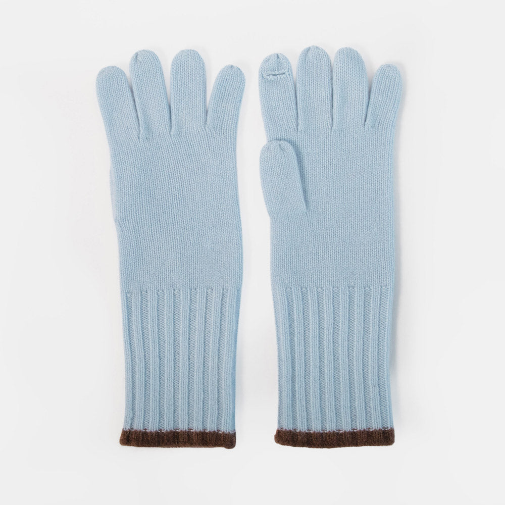 A pair of light blue knit gloves with ribbed cuffs and a contrasting dark brown trim, displayed flat against a clean white background.