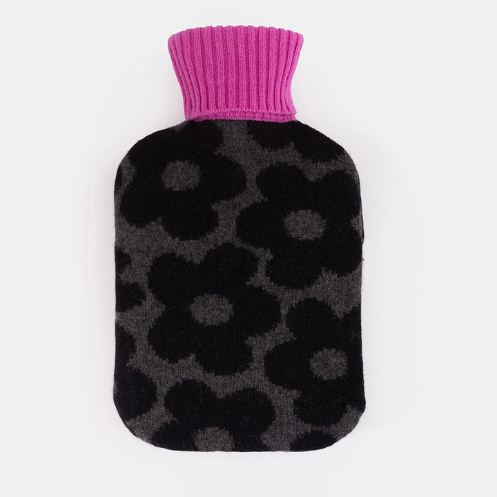 Pure merino wool hot water bottle with a black flower knit on a charcoal base and a fuchsia cashmere ribbed neck