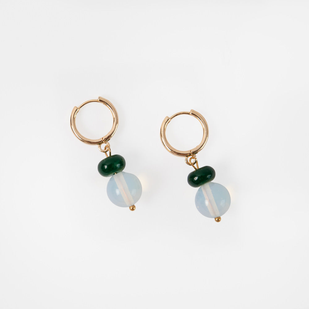 Pair of gold hoop earrings with green and blue beads on a white background