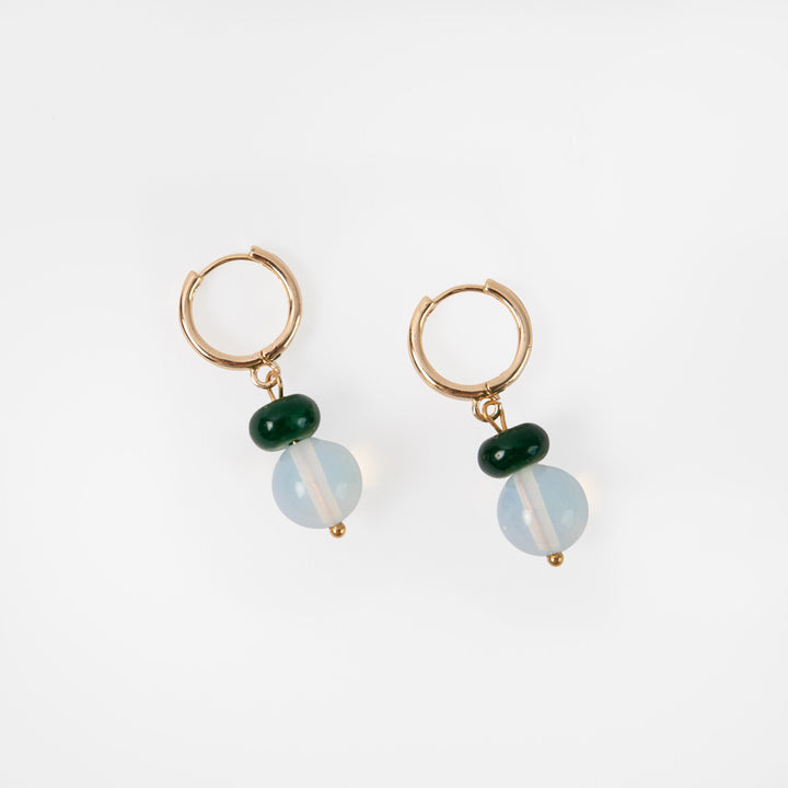 Pair of gold hoop earrings with green and blue beads on a white background