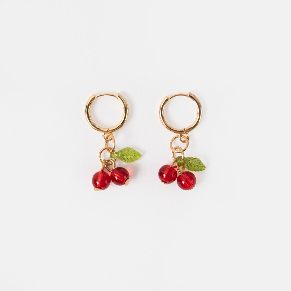 gold hoop earrings with red cherry shaped glass beads and green leaves