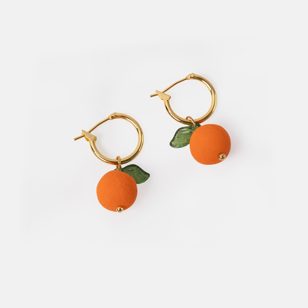 gold hoop earrings with orange shaped charms with green leaves