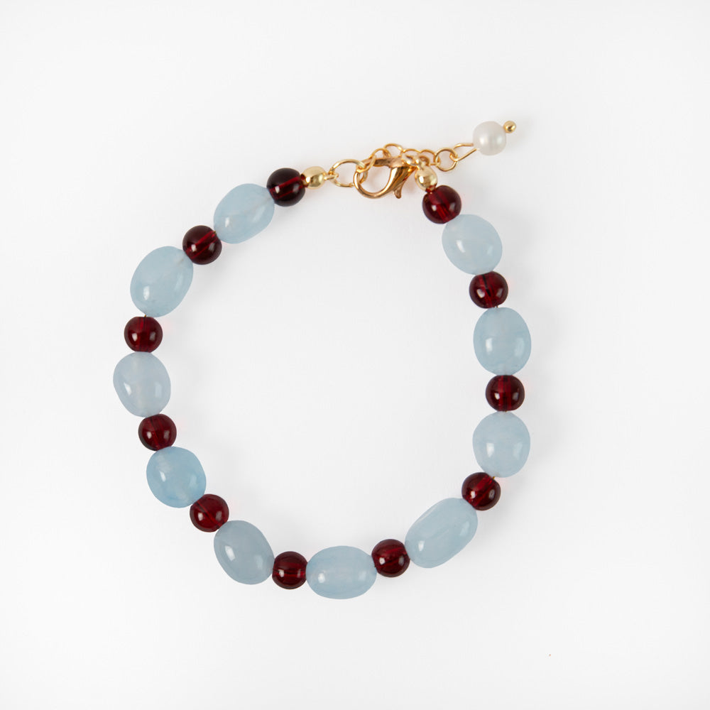 light blue & burgundy beaded bracelet on a white background