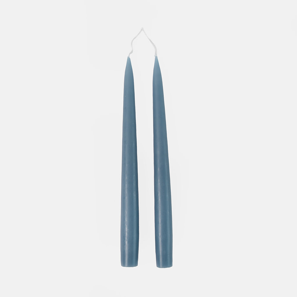 Two blue candles on a white background