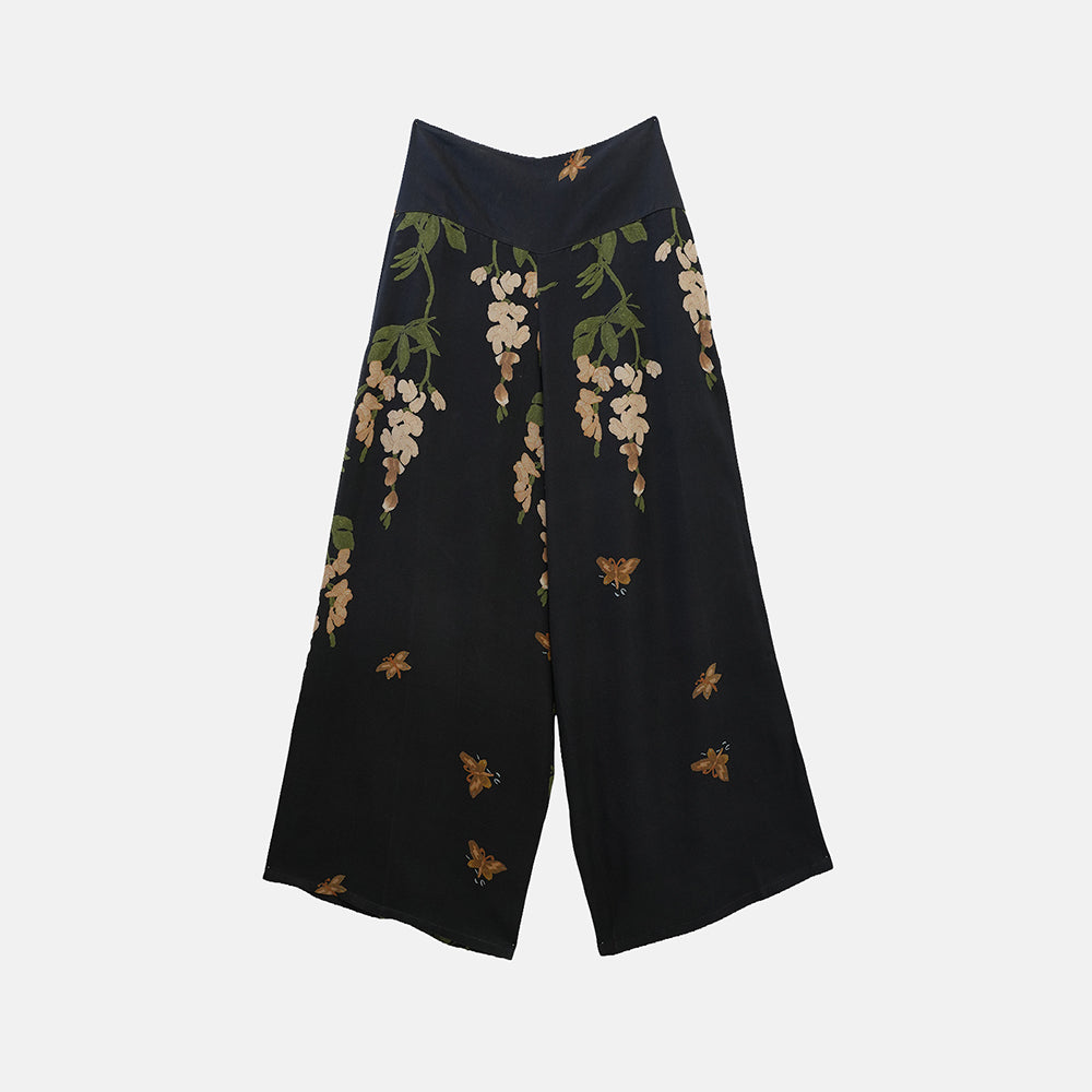 Black wide-leg cropped pants featuring a floral and butterfly print, displayed flat against a light gray background.