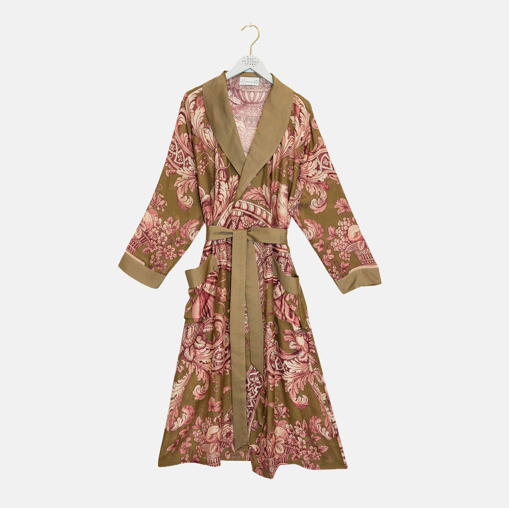 A long-sleeve wrap robe with a brown and pink floral pattern, featuring solid brown trim on the collar, cuffs, and belt, hanging on a white hanger against a light gray background.