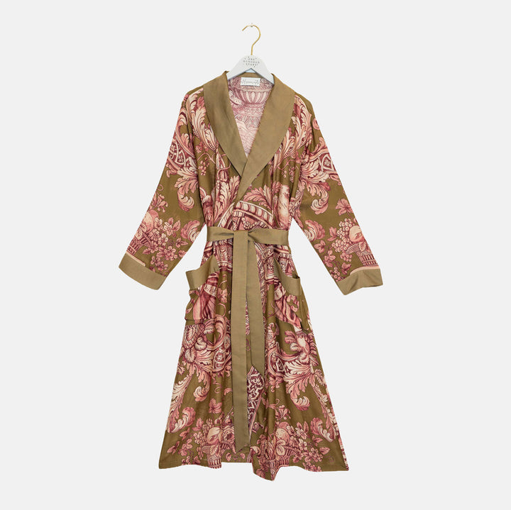 A long-sleeve wrap robe with a brown and pink floral pattern, featuring solid brown trim on the collar, cuffs, and belt, hanging on a white hanger against a light gray background.